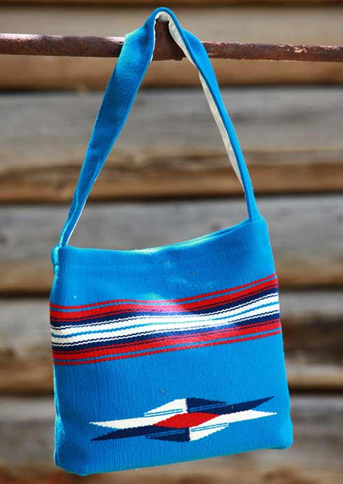 Blue bag with red, black and white stripes